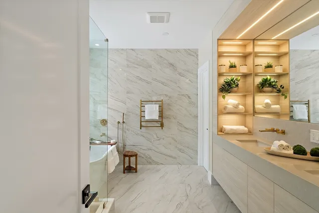 a view of an empty room and a kitchen