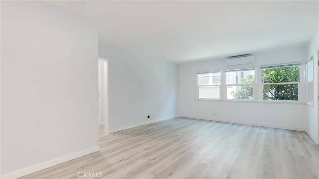 239 3rd Avenue Venice, CA 90291 - Photo 11 of 24 an empty room with wooden floor and windows