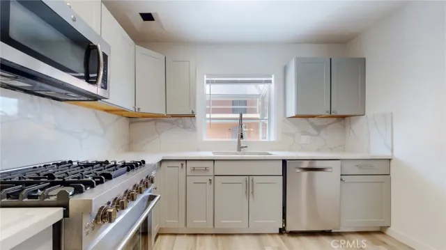 a kitchen with cabinets appliances and a sink