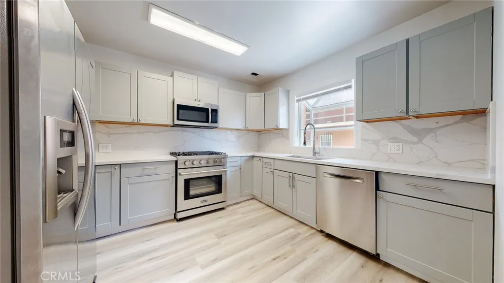 239 3rd Avenue Venice, CA 90291 - Photo 2 of 24 a kitchen with cabinets appliances and a sink