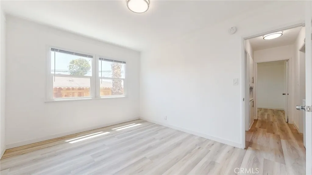 239 3rd Avenue Venice, CA 90291 - Photo 6 of 24 an empty room with wooden floor and windows