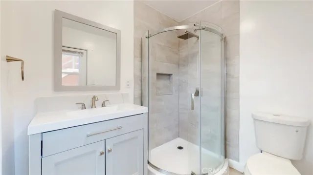 a bathroom with a sink toilet and shower