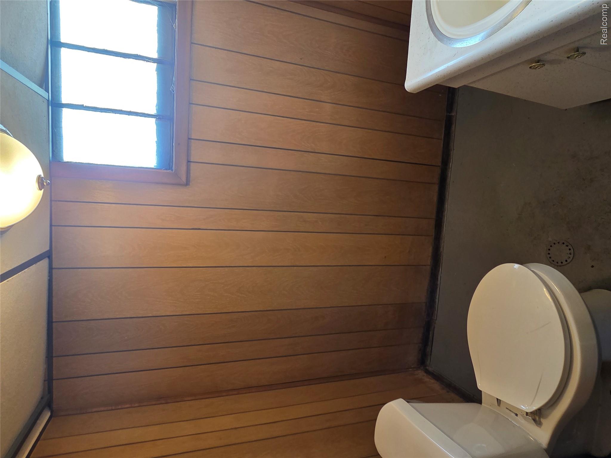 5274 Nottingham Road Detroit, MI 48224 - Photo 17 of 18 Bathroom with vanity and wood walls