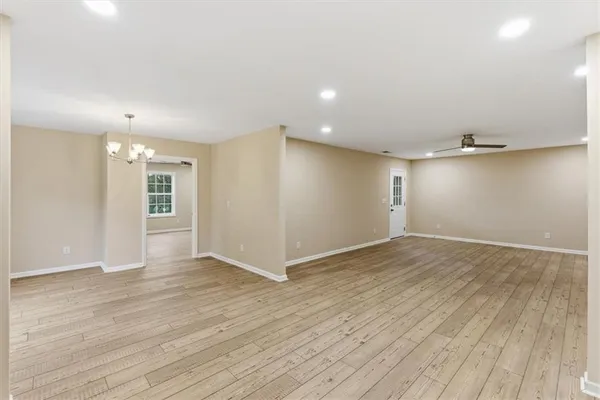 a view of an empty room with wooden floor
