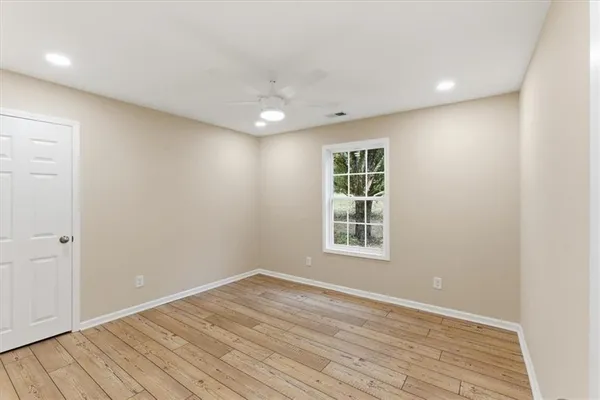 wooden floor in an empty room with a window