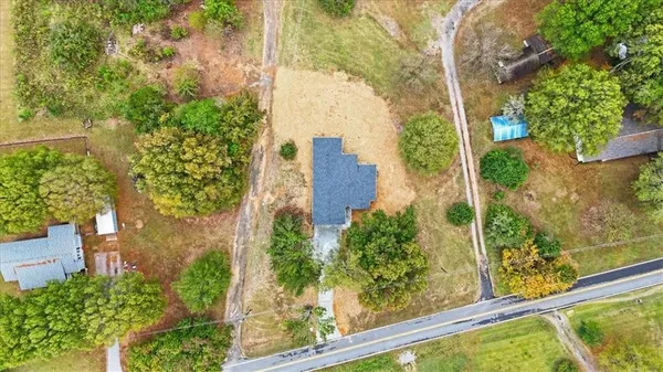 an aerial view of a residential houses with yard