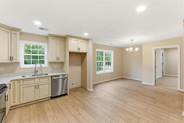 a kitchen with a sink a window and stainless steel appliances