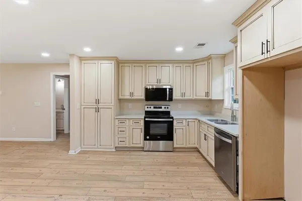 a kitchen with stainless steel appliances granite countertop a refrigerator and a stove top oven