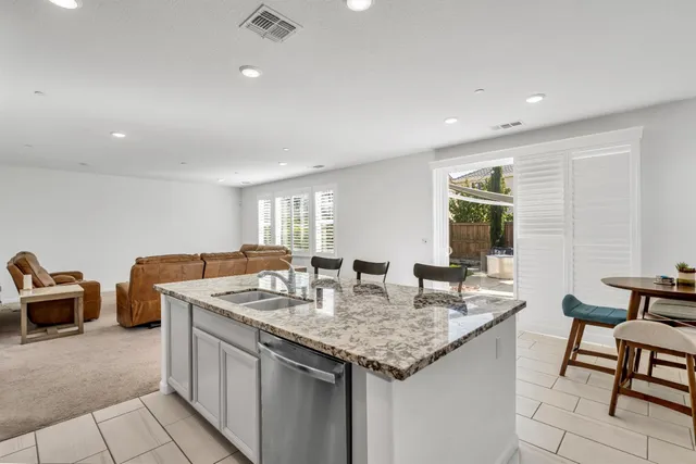 a view of staircase with white walls and a rug