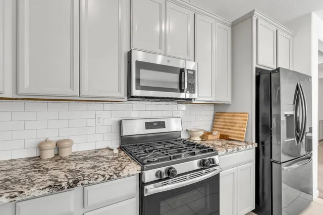 a bedroom with bed and a large window