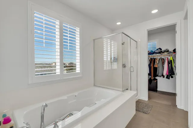 a bathroom with double vanity sinks and a mirror