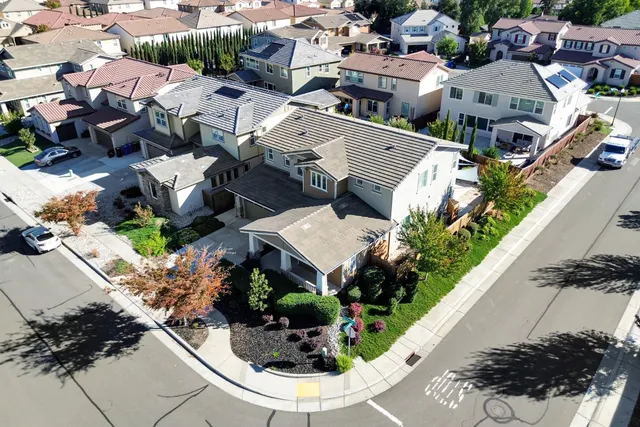 an aerial view of a house with a yard