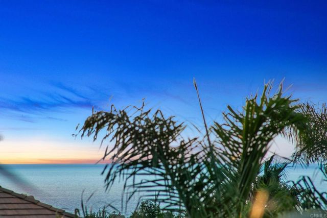 a view of backyard with swimming pool and seating