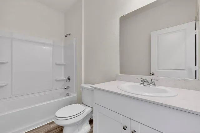 a kitchen with granite countertop stainless steel appliances sink stove microwave and cabinets