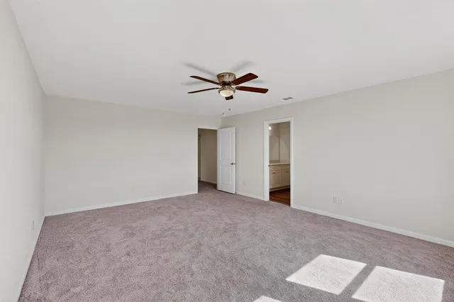 a view of a livingroom with a ceiling fan and window