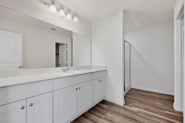 an empty room with a ceiling fan and a window