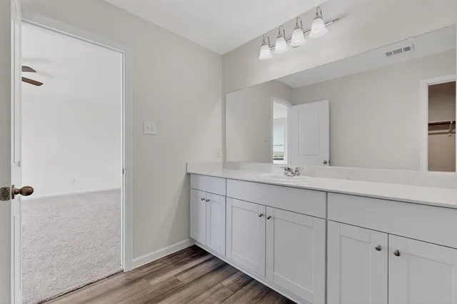 a bathroom with a double vanity sink and a mirror