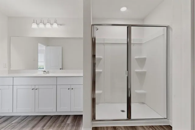 a bathroom with a double vanity sink and a mirror