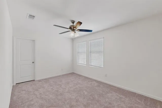 a bathroom with a mirror a sink and a window