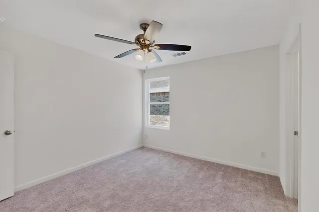 a view of room with a ceiling fan and window