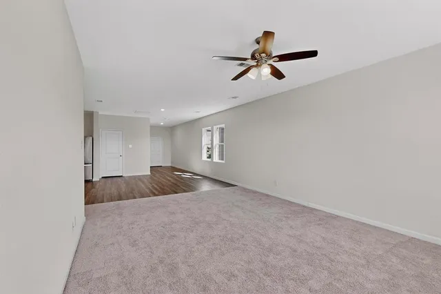 a view of a livingroom and a ceiling fan