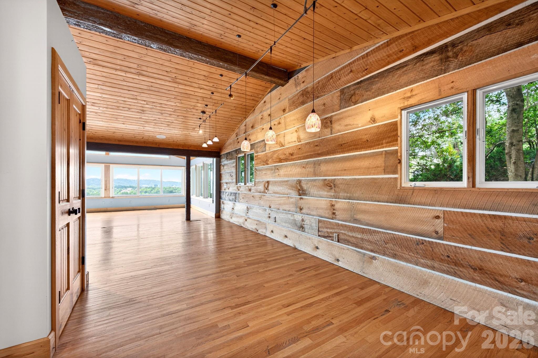 38 Lookout Road Asheville, NC 28804 - Photo 12 of 34 a view of an empty room with wooden floor and a window