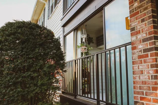 a view of a balcony with wooden floor and fence