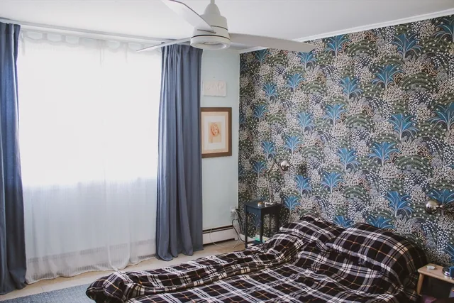 a bedroom with a bed and a window