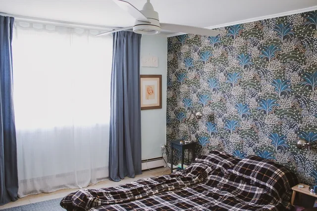 a bedroom with a bed and a window