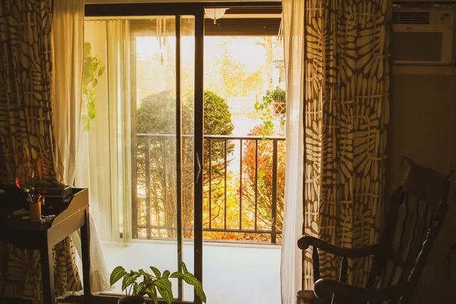 a view of a balcony with wooden floor