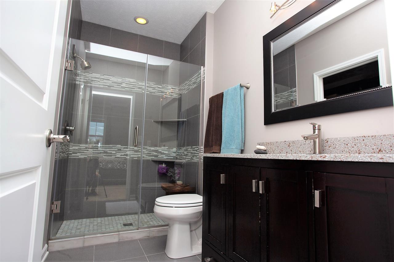4403 Perry Ridge Lane Loves Park, IL 61111 - Photo 17 of 25 a bathroom with a double vanity sink toilet and shower