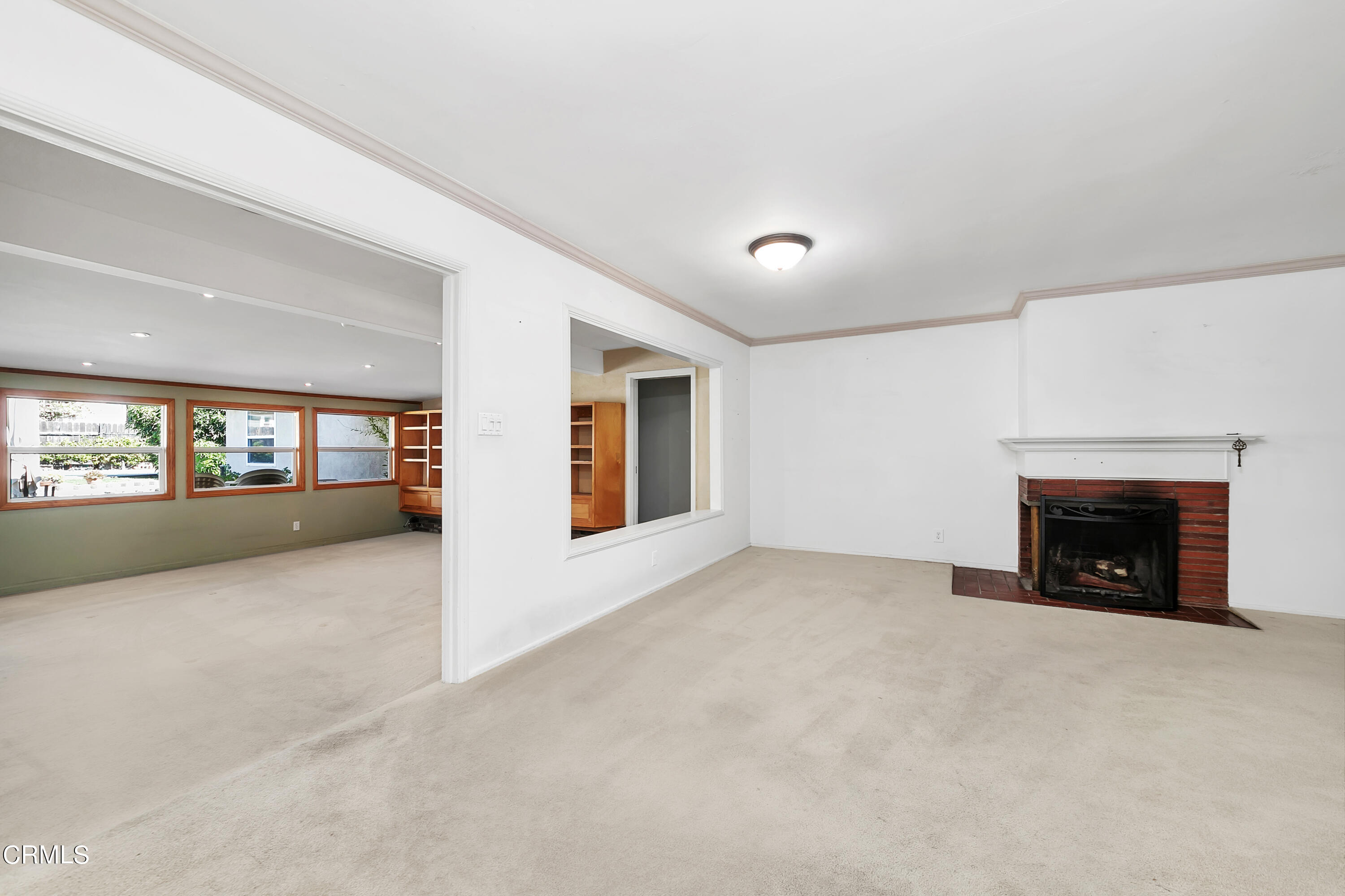 3755 Mayfair Drive Pasadena, CA 91107 - Photo 7 of 37 an empty room with fireplace and windows