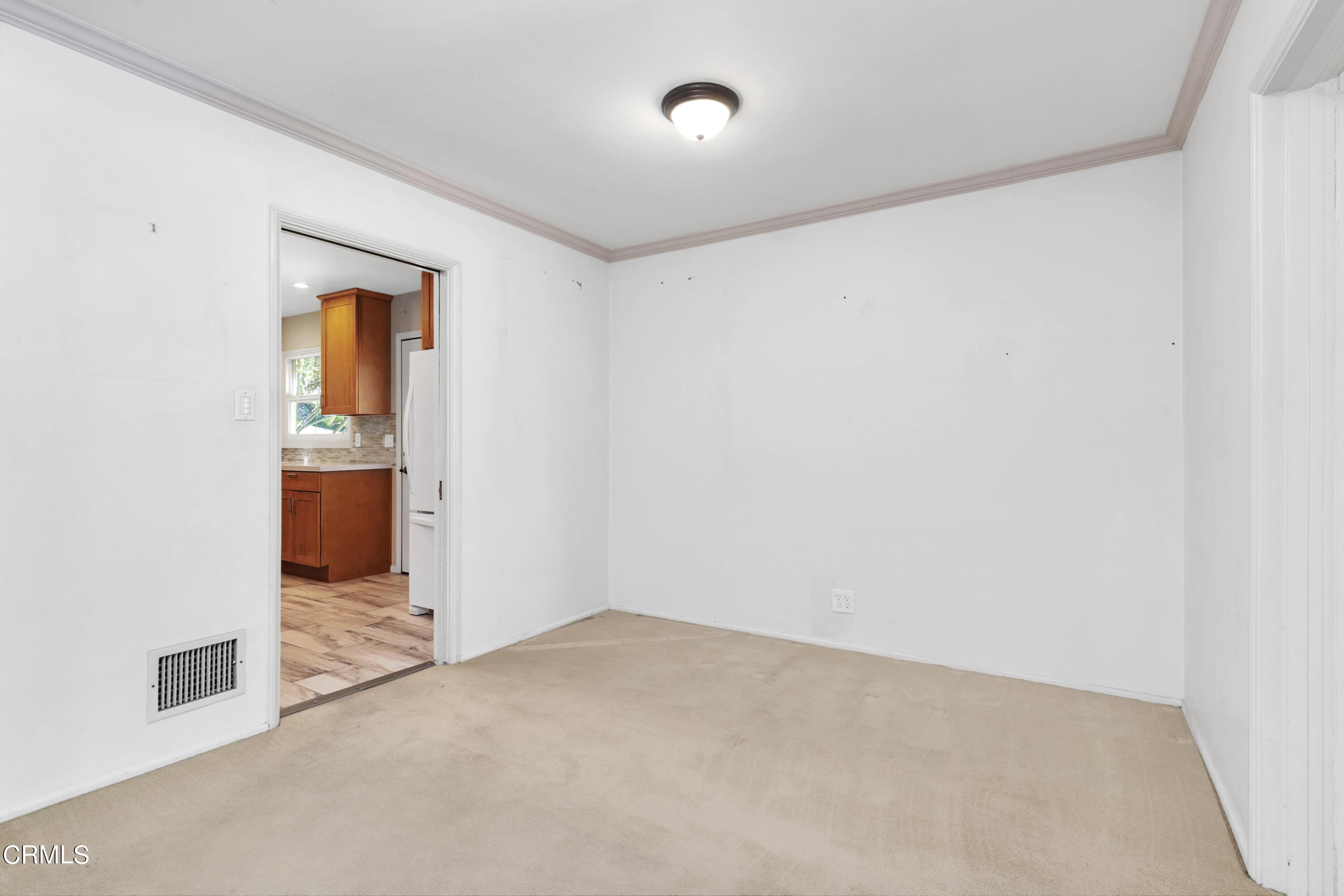 3755 Mayfair Drive Pasadena, CA 91107 - Photo 8 of 37 an empty room with wooden cabinet and windows