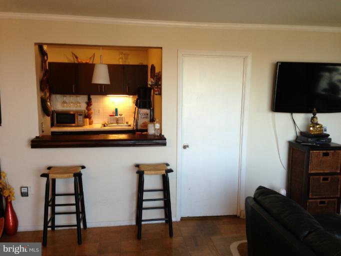 3245 Rio Drive, Unit 806 Falls Church, VA 22041 - Photo 5 of 5 a living room with furniture and a flat screen tv
