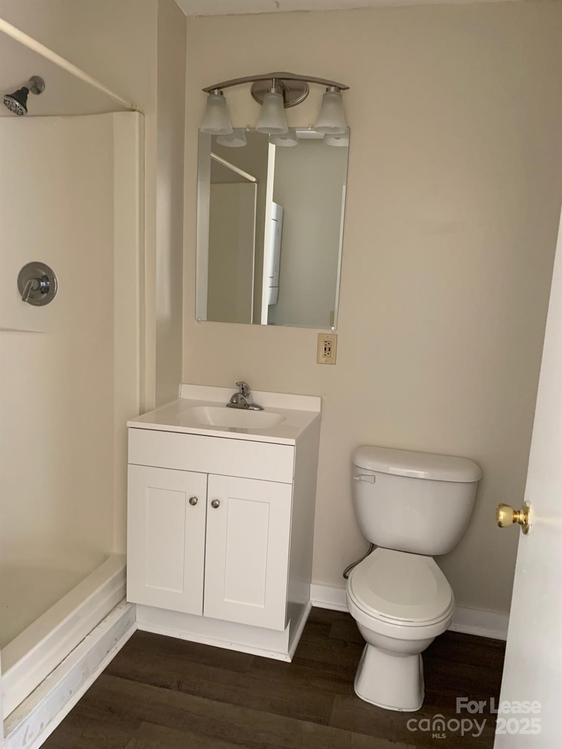 128 Zeb Street, Unit C101 Boone, NC 28607 - Photo 11 of 17 a bathroom with a toilet sink and mirror