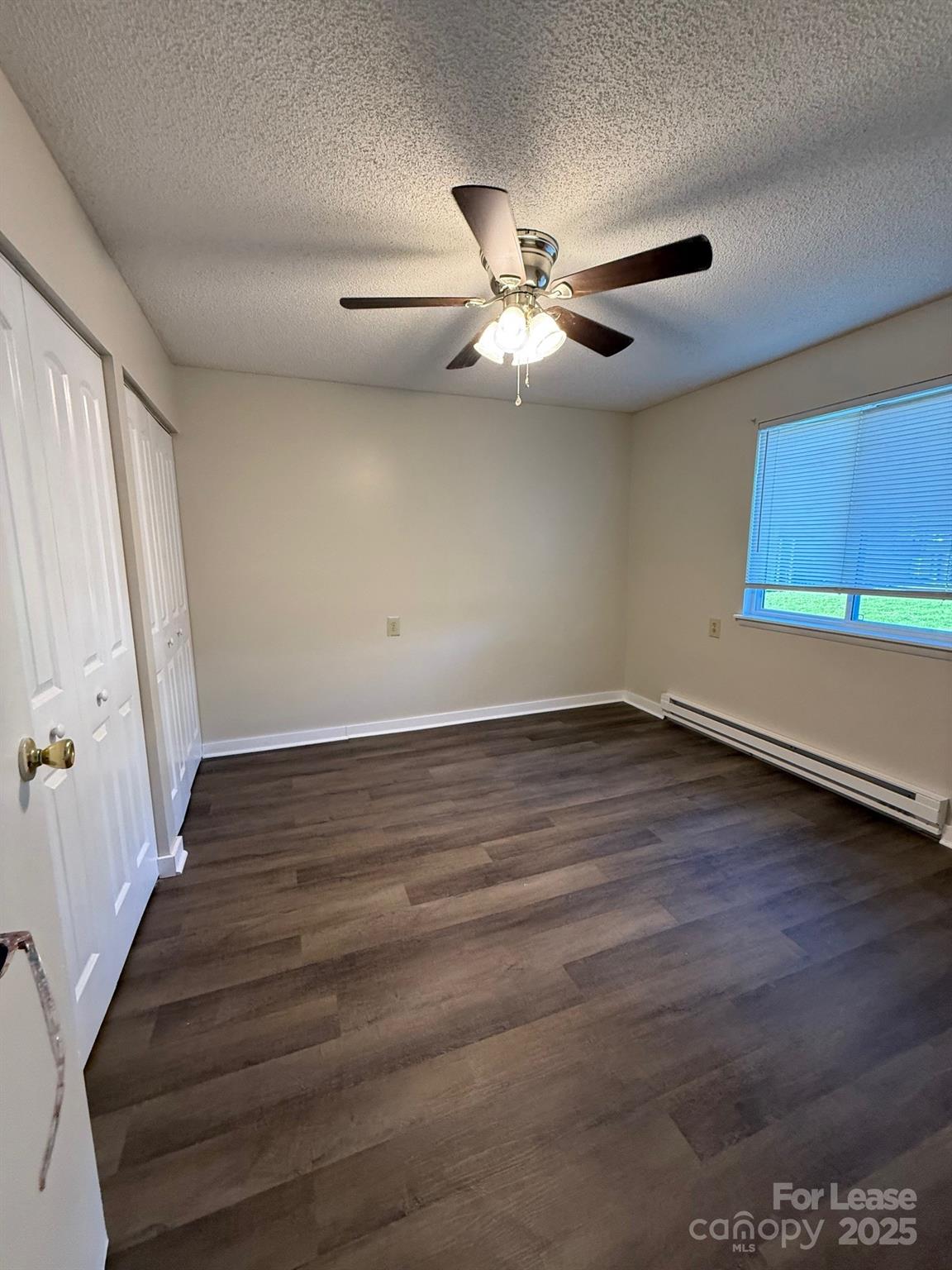 128 Zeb Street, Unit C101 Boone, NC 28607 - Photo 13 of 17 an empty room with wooden floor fan and windows