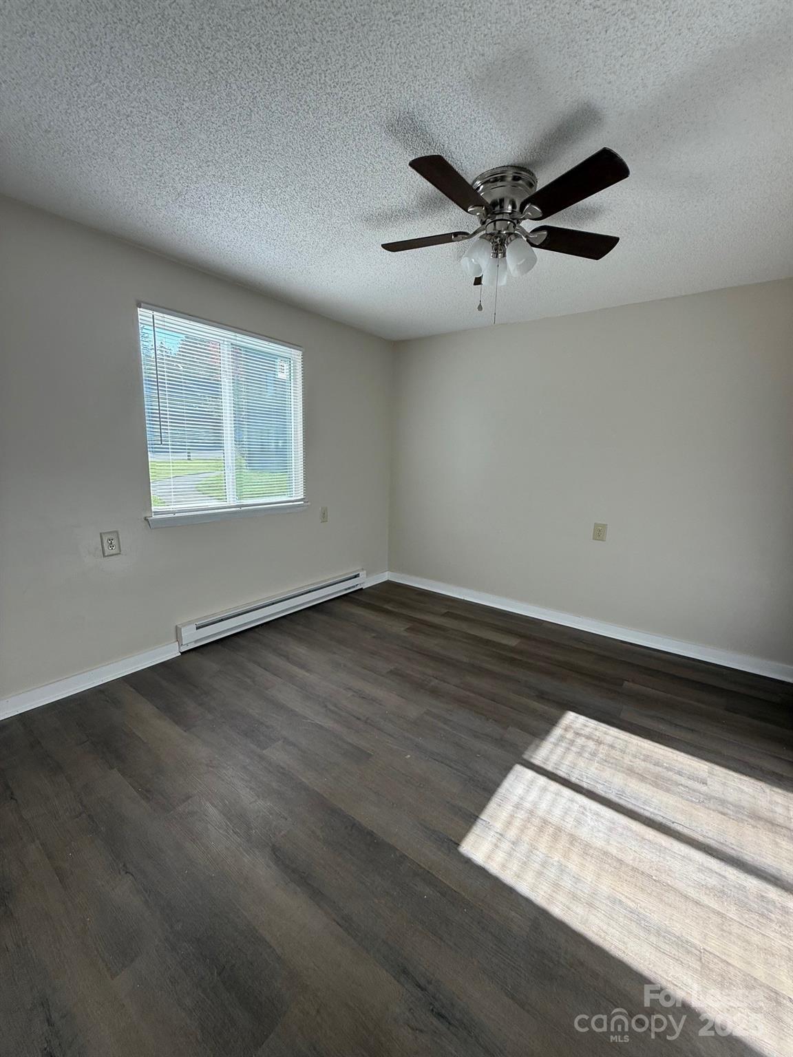 128 Zeb Street, Unit C101 Boone, NC 28607 - Photo 16 of 17 an empty room with wooden floor fan and windows