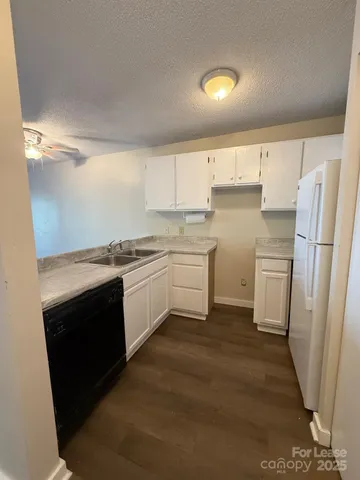 a kitchen with a sink stove and refrigerator