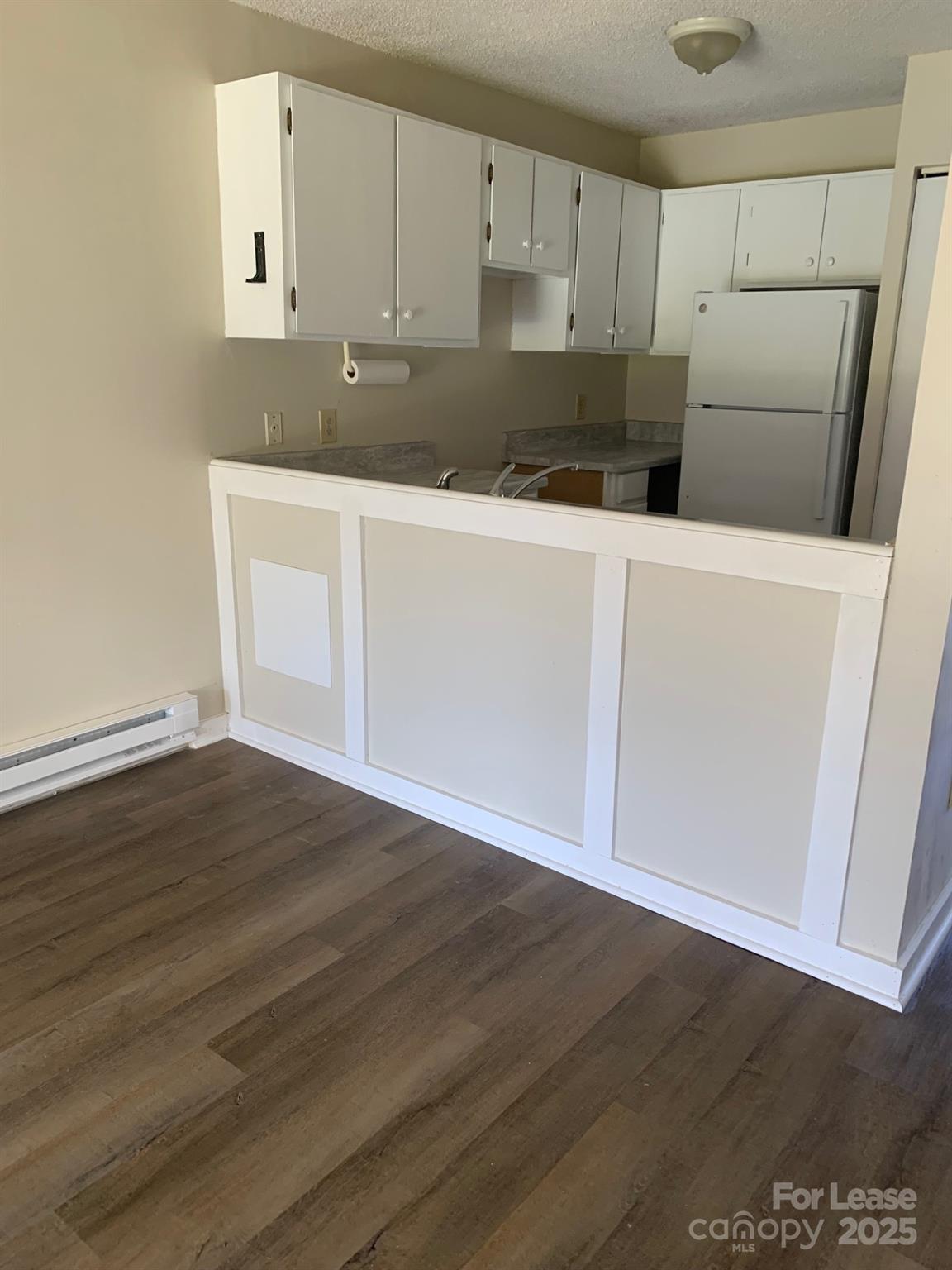 128 Zeb Street, Unit C101 Boone, NC 28607 - Photo 6 of 17 a kitchen with granite countertop a sink and a refrigerator