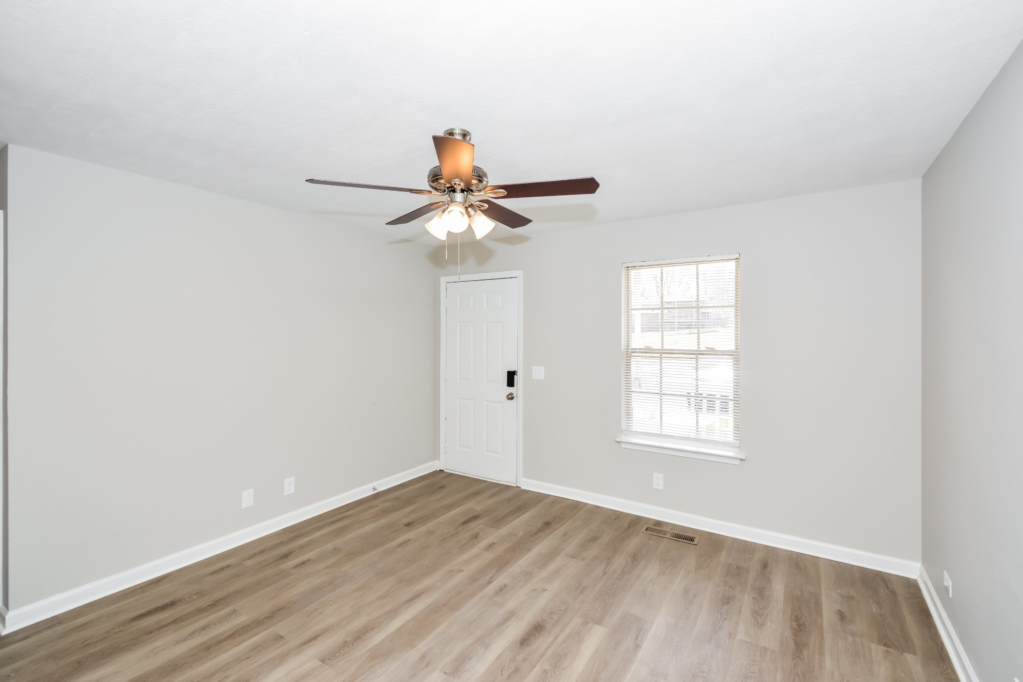 2607 Landrum Court, Unit 8 Springfield, TN 37172 - Photo 3 of 17 an empty room with wooden floor fan and windows