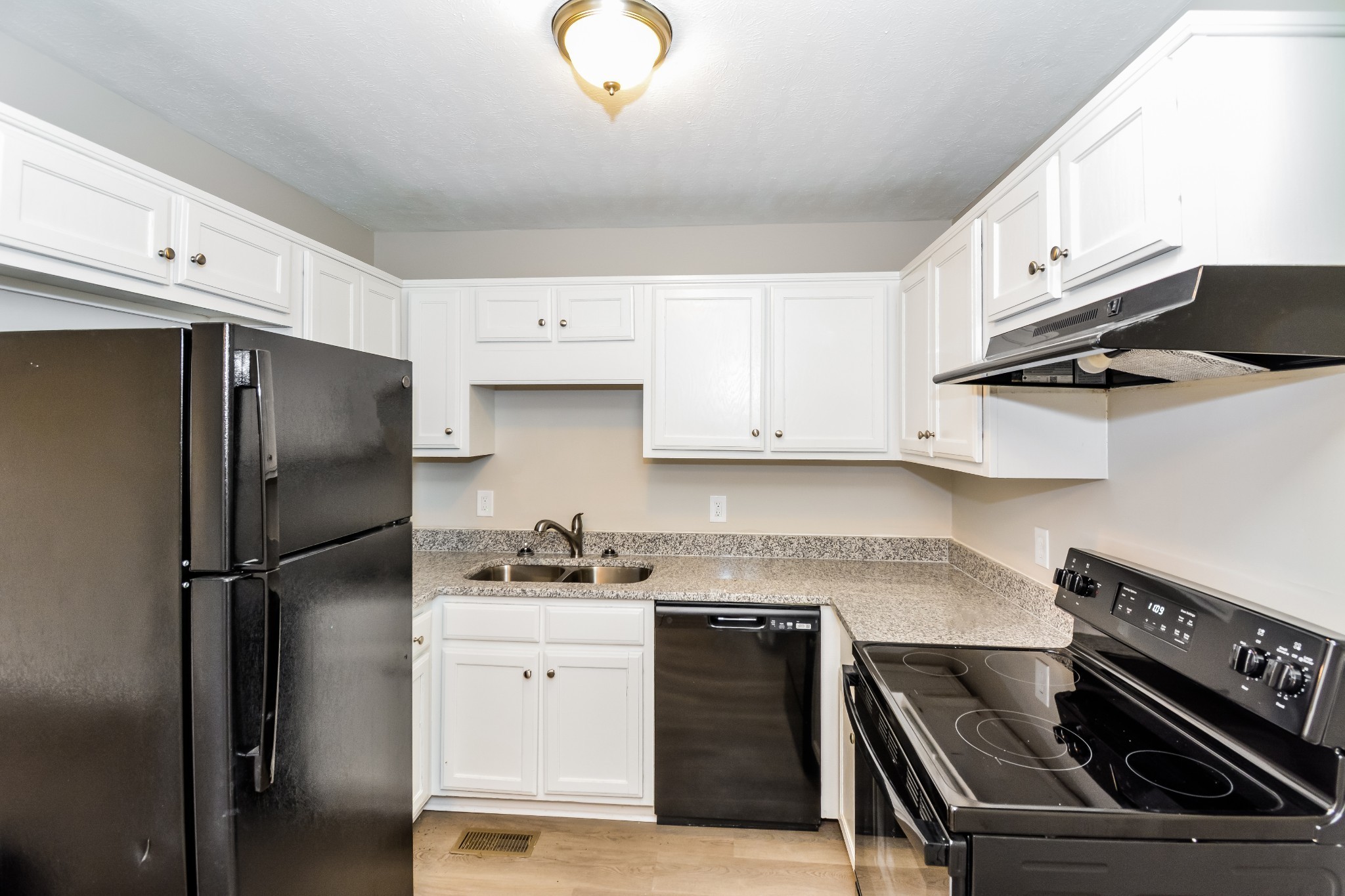 2607 Landrum Court, Unit 8 Springfield, TN 37172 - Photo 4 of 17 a kitchen with a refrigerator stove and white cabinets