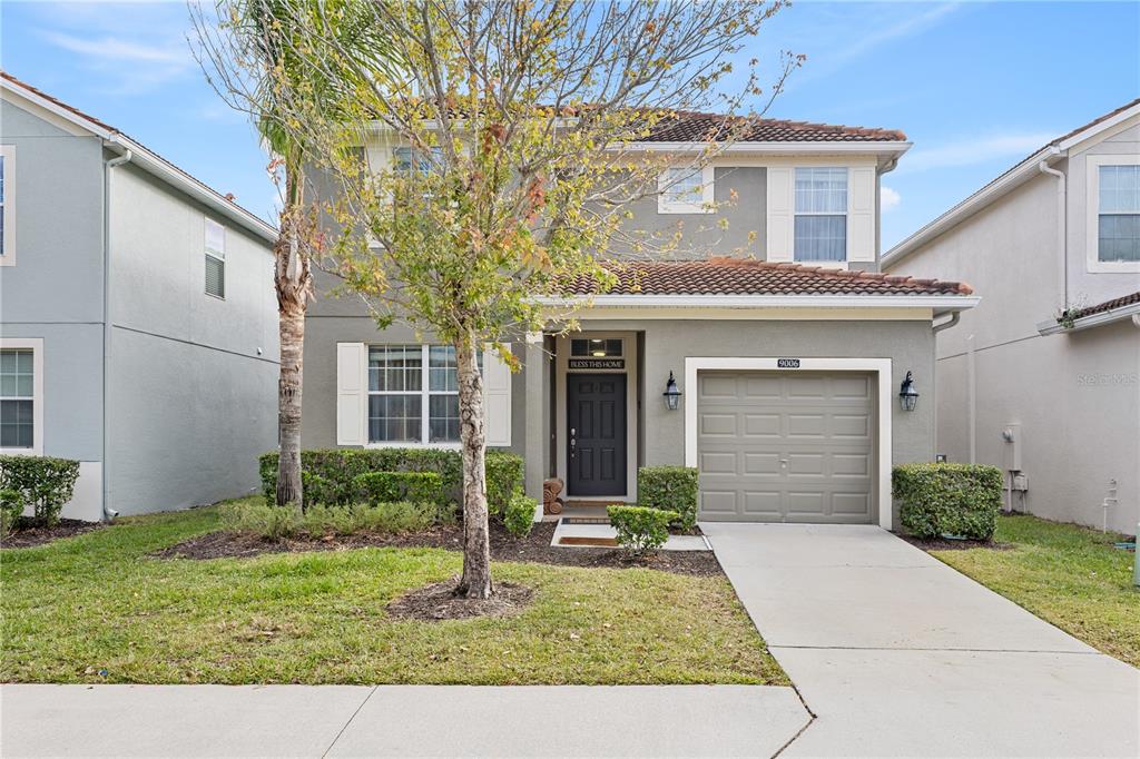 9006 Majesty Palm Road Kissimmee, FL 34747 - Photo 1 of 56 a view of a house with a yard