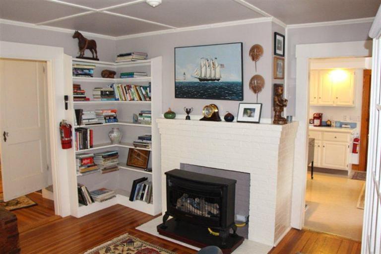 137 Jefferson Road Bourne, MA 02532 - Photo 13 of 28 a living room with a fireplace and a wooden floor