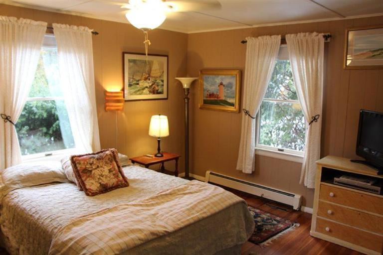 137 Jefferson Road Bourne, MA 02532 - Photo 17 of 28 a bedroom with a bed and a flat tv screen on dresser