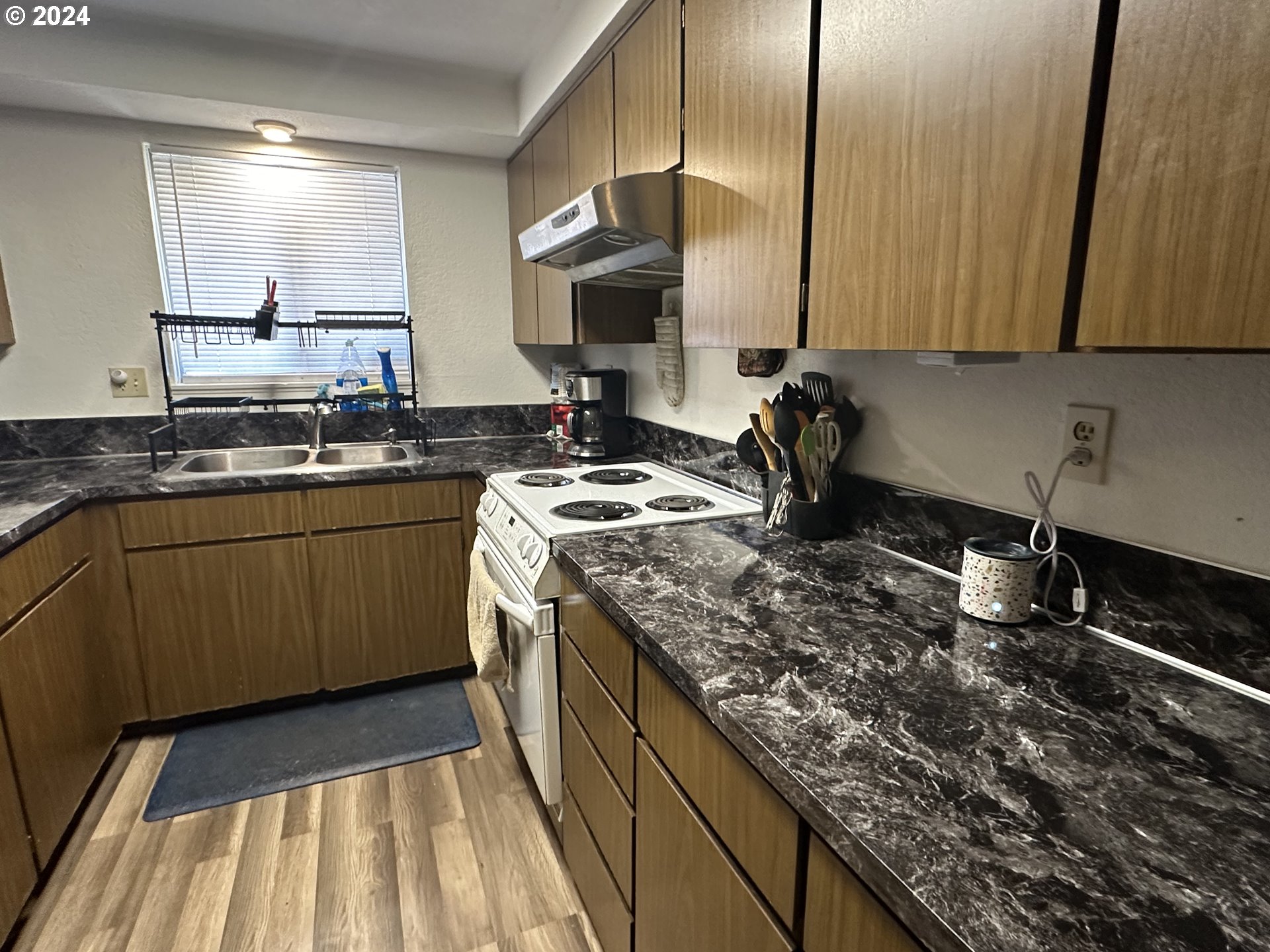 121 Copper Way Riddle, OR 97469 - Photo 2 of 21 a kitchen with a sink stove and cabinets