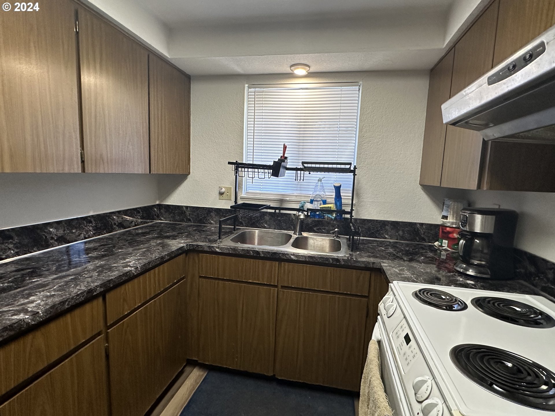 121 Copper Way Riddle, OR 97469 - Photo 3 of 21 a kitchen with a sink a stove and cabinets