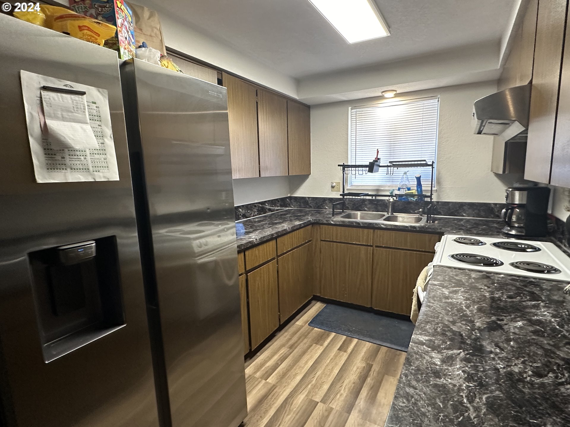 121 Copper Way Riddle, OR 97469 - Photo 4 of 21 a kitchen with stainless steel appliances granite countertop a sink stove and refrigerator