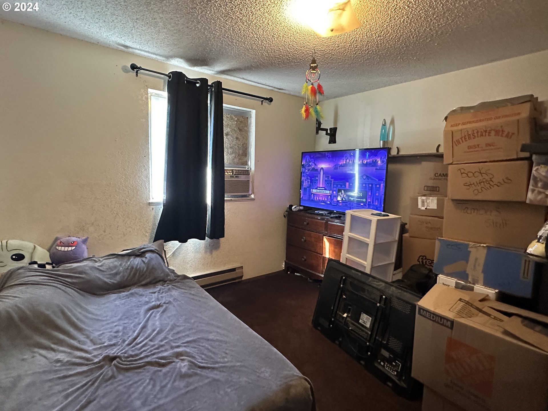 121 Copper Way Riddle, OR 97469 - Photo 10 of 21 a bedroom with a bed and a television in it