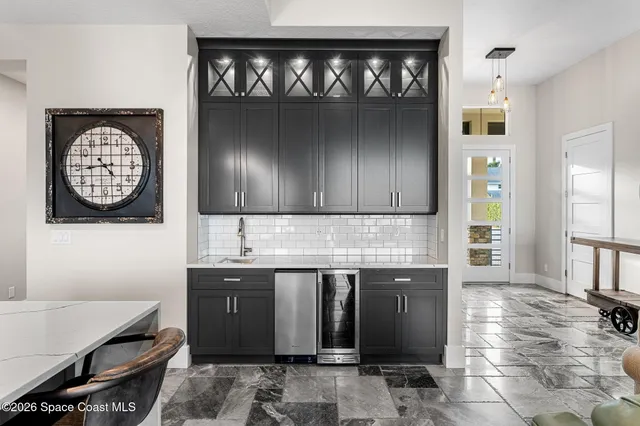 a view of a hallway with furniture and a chandelier