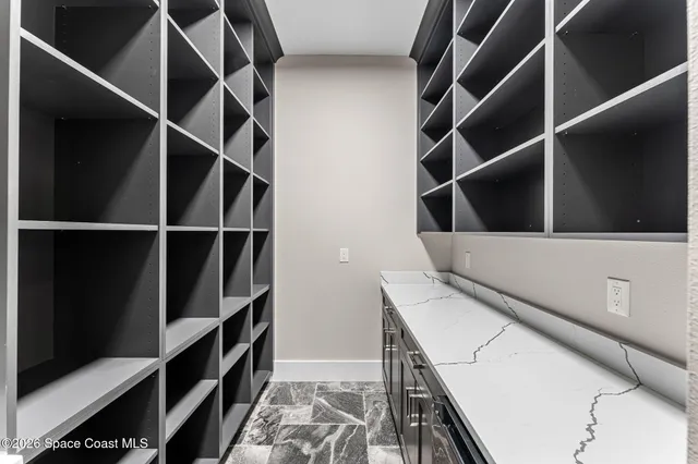 a view of a house with a large space and a car parked in front of it